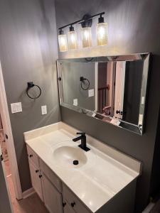 a bathroom with a sink and a mirror at Convenient 3 bedroom Townhome in Raleigh