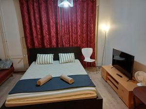 a bedroom with a bed with two logs on it at Air conditioned Apartment in Espoo