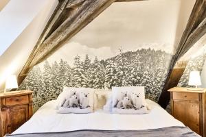 a bedroom with a mural of snow covered trees at Logis Hotel Saint-Martin in Colmar
