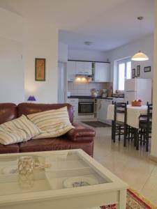 a living room and kitchen with a couch and a table at Casa Allure in Višnjan