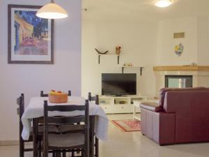 a living room with a table and a tv at Casa Allure in Višnjan