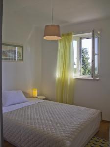 a bedroom with a bed and a window at Casa Allure in Višnjan +38 photos