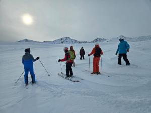 a group of people on skis in the snow at Syrgak in Dzhergalan