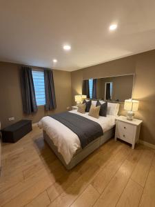 a bedroom with a large bed and a window at GRAPHITE APARTMENTS in Inverness