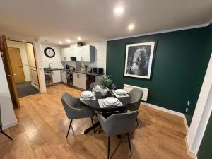 a kitchen and dining room with a table and chairs at GRAPHITE APARTMENTS in Inverness