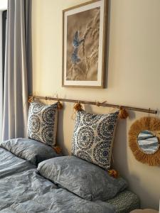 a bedroom with a bed with pillows on it at Radawa LOVE in Radawa