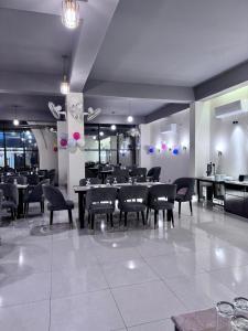 a restaurant with tables and chairs in a room at Grand Khalifa Hotel Hamama in Sylhet