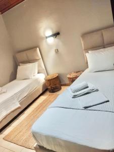 a bedroom with two beds with white sheets at Villa La Bohème, Nafpliο in Nea Kios +42 photos