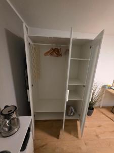 a cupboard in the corner of a kitchen at Apartment Tanne in Düsseldorf +5 photos