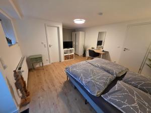 a bedroom with a bed and a desk with a computer at Apartment Tanne in Düsseldorf