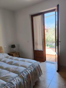 a bedroom with a bed and a sliding glass door at Casa I Limoni in Viareggio