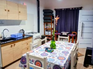a kitchen with a table with a vase on it at Elmosquetal in Villa Yacanto