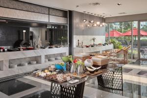 a buffet in a restaurant with food on a table at Novotel Executive Hotel at Rosalina Acqua Residence Mandaluyong in Manila