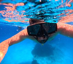 a man in a swimming pool wearing goggles at B&B La Dimora di Lulù in Trapani