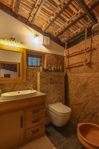 a bathroom with a toilet and a sink at The Oneness Living- Seasonal Heritage stay with Tholpaavakoothu nights in Pazhayannūr