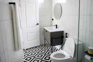 a bathroom with a toilet and a sink and a mirror at Travellers Palm in Ko Phangan