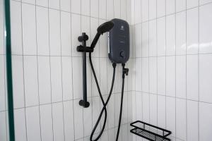 a phone hanging on a wall in a bathroom at Travellers Palm in Ko Phangan +6 photos