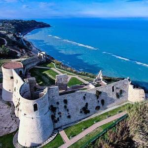a castle on top of a hill next to the ocean at La Presentosa in Ortona