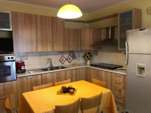 a kitchen with a table with a yellow table cloth on it at La Presentosa in Ortona