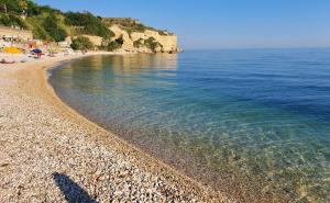 a beach with a rocky shore and the ocean at La Presentosa in Ortona +2 photos