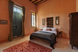 a bedroom with a bed and a window and a door at Beit Felfel in Esna