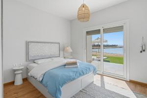a bedroom with a bed and a view of the ocean at The Sandy Feet Sea Front in Hurghada +38 photos