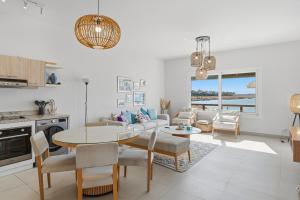 a kitchen and living room with a table and chairs at The Sandy Feet Sea Front in Hurghada