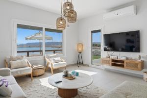 a living room with a tv and a couch and a table at The Sandy Feet Sea Front in Hurghada