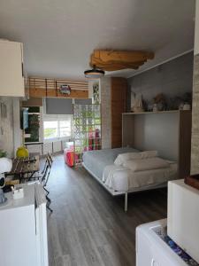 a bedroom with a large bed and a kitchen at SALTILLO ALTO WHITE STUDIO in Torremolinos