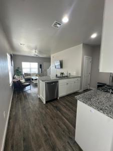 a kitchen with a counter top and a living room at Spacious Family Townhouse in Edmond