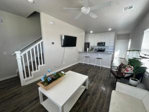 a living room with a white couch and a table at Spacious Family Townhouse in Edmond