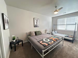 a bedroom with a bed and a table in it at Spacious Family Townhouse in Edmond