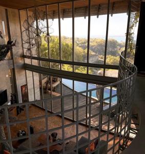 a spiral staircase in a room with a large window at Dacolina House Jimbaran in Jimbaran