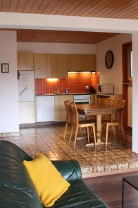 a kitchen and dining room with a table and chairs at Anzère appartement de vacances calme et sympa in Anzère