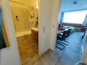 a bathroom with a shower and a sink and a tub at Studio Almwiese in Kaprun