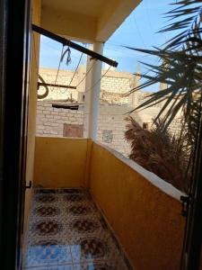 an open door to a balcony with a view of a building at Aylan in Siwa