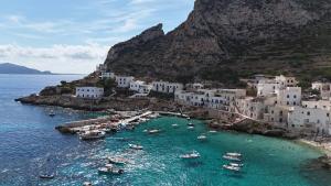 a group of boats in the water near a beach at B&B La Dimora di Lulù in Trapani