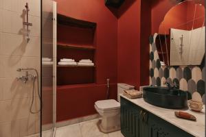 a bathroom with a toilet and a sink and a shower at Beit Felfel in Esna