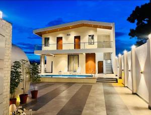 a villa with a swimming pool at night at Vasudeva Villas in Udaipur