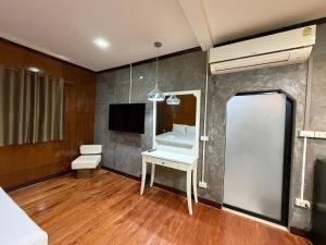 a room with a white table and a tv at Kiriraya Resort in Ao Nang Beach