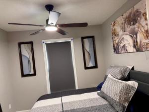 a bedroom with a ceiling fan and a bed at Convenient 3 bedroom Townhome in Raleigh