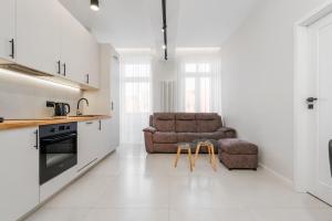 a kitchen and living room with a couch and a table at K26UrbanNest in Wrocław