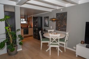 a kitchen and dining room with a table and chairs at Classic Stavanger Townhouse, Garden, Spacious in Stavanger