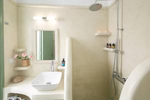a bathroom with a sink and a shower at Elite Houses Santorini in Emporio