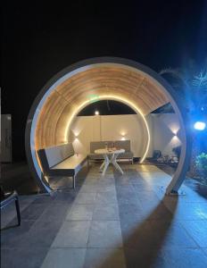 a room with a couch and a table in a tunnel at Vasudeva Villas in Udaipur +5 photos