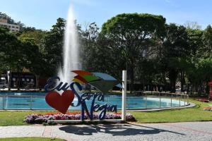 a fountain in a park with a sign with a heart at kit net central 2 in Serra Negra +9 photos