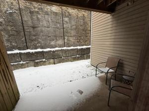 an outside room with a chair and a wall at Branson Ridge Retreat in Branson