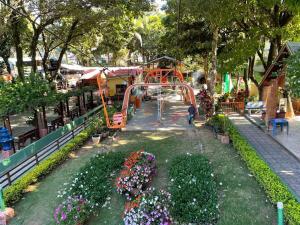 a roller coaster in a park with flowers at kit net central 2 in Serra Negra