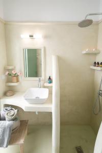 a bathroom with a sink and a mirror at Elite Houses Santorini in Emporio