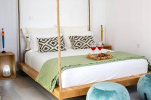 a bedroom with a swing bed with two glasses of wine at Elite Houses Santorini in Emporio +48 photos